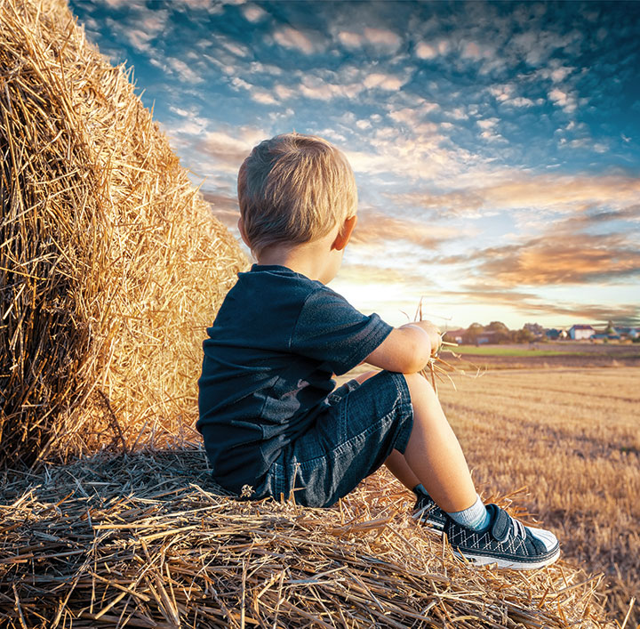 Little Kid in wheat stubble field